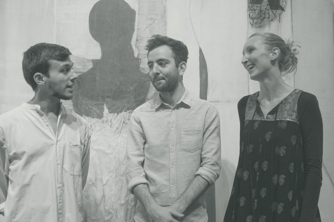 Seb, Will and Sylvia talking in front of a large painted canvas